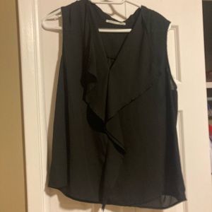 Black sleeveless blouse with waterfall neckline.